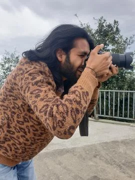 Closeup side view of a good looking young man with long hair and beard Stock Photos