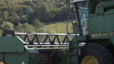 Closeup side view of green combine harvester Video stock 122773993