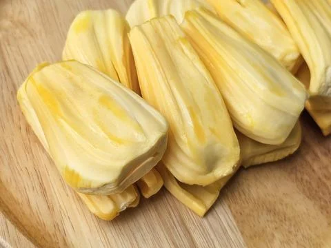 Closeup side view of jackfruit pulp on wooden board Stock Photos