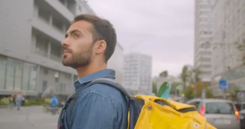 Closeup side view portrait of bearded caucasian delivery man with backpack Stock Footage 114820866