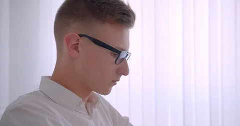 Closeup side view portrait of young handsome caucasian businessman in glasses Video stock 111318094
