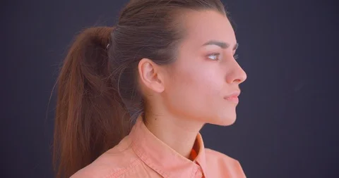 Closeup side view portrait of young pretty caucasian female looking forward and Video stock 112136797