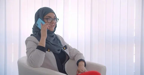 Closeup side view portrait of young muslim attractive female doctor in hijab and Video stock 112884895