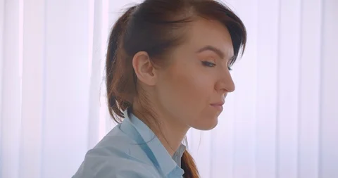 Closeup side view portrait of young successful attractive caucasian female Stock Footage 115359261