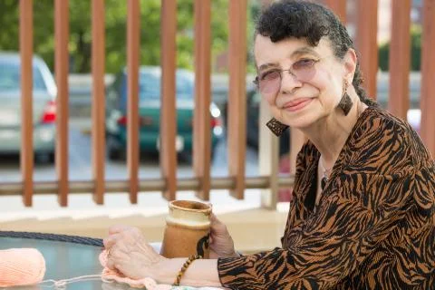 Closeup side view profile portrait, grandmother enjoying cup of drink, isolat Stock Photos