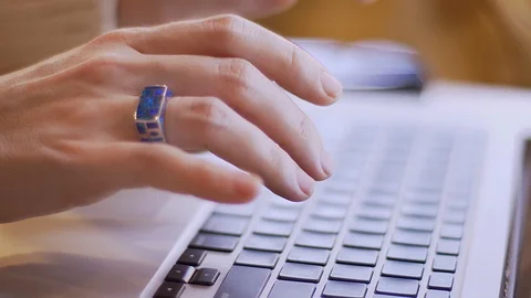 Closeup side view shoot of female hands typing on the laptop indoors in a cozy Video stock 107663150