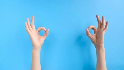 Closeup side view of unrecognizable female shows an ok sign with both hands Stock Footage 116674088