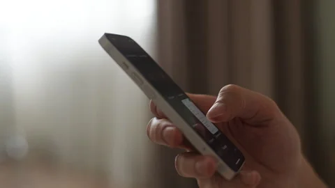 Closeup side view of unrecognizable male hand holding mobile phone typing text Stock Footage 265026847