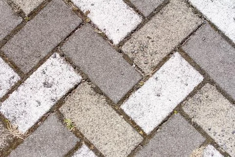 Closeup of sidewalk paved with rectangular white and gray tiles in top view Foto stock