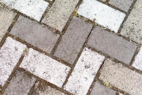 Closeup of sidewalk paved with rectangular white and gray tiles in top view Stock Photos