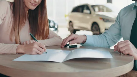Closeup signing agreement or contract for getting new credit card represented by Stock Footage 180657582