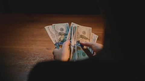 Closeup silhouette person hands counting dollar bills. calculating income Stock Footage 327986825