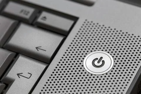 Closeup of silver computer laptop selective focus on standby on button ideal Stock Photos