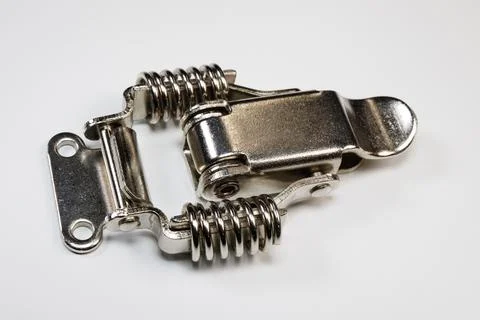 Closeup of silver spring latch on white background Foto stock