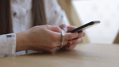 Closeup sitting woman hands using touchscreen smartphone mobile device sharing Video stock 75609387