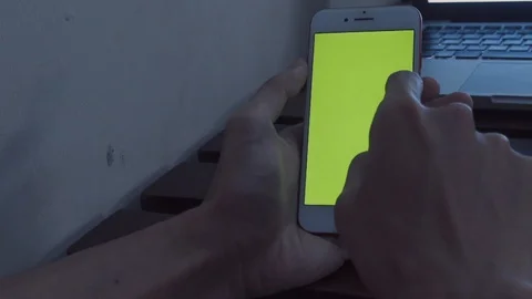 Closeup sitting wooden table hands scrolling smartphone with green screen Stock Footage 110449169