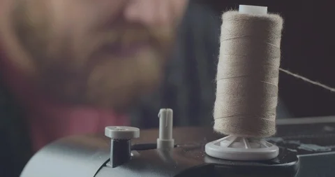 Closeup skein of gray thread on a working professional sewing machine. cinema 4k Stock Footage 121536215