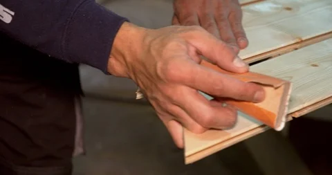 Closeup of skilled carpenter working, polishing wooden plank piece of timber Stock Footage 122568391
