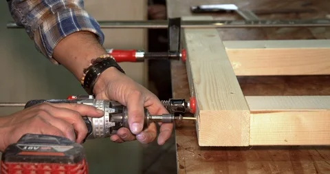 Closeup of skilled carpenter working with screwdriver In workshop Stock Footage 122576233