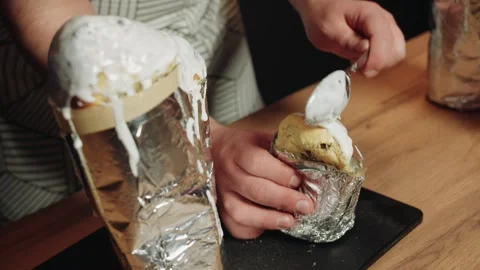 Closeup of skilled chef applying shiny icing to baked treat with precision Video stock 330537160