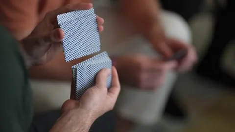 Closeup Of Skillful Card Handling In Warm Setting, Detailed Shot Capturing Vidéo 323770105
