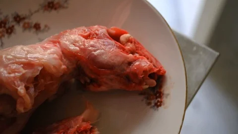 Closeup of the skinned head of a rabbit on a plate, waiting to be cooked. Stock Footage 100883639