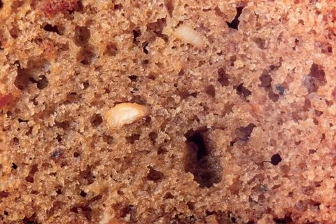 Closeup of a slice of bread with nuts Whole background Stock Photos