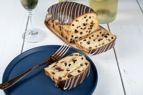 Closeup of slice of Chocotone surrounded by fork, glass and bottle of spark.. Stock Photos