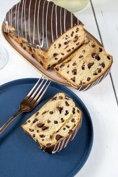 Closeup of slice of Chocotone surrounded by fork, glass and bottle of spark.. Stock Photos