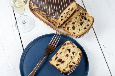 Closeup of slice of Chocotone surrounded by fork, glass and bottle of spark.. Stock Photos