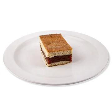 Closeup of a slice of layered cake isolated on white backg Stock Photos