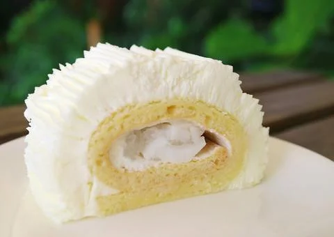 Closeup a Slice of Light and Fluffy Young Coconut Roll Cake Photos