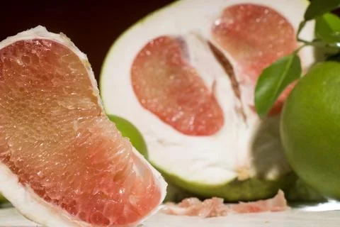 Closeup, sliced ​​red pomelo fruit, on the table Stock Photos