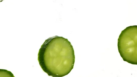 Closeup slices of fresh green cucumbers in water, vegetables on white background 스톡 동영상 268168905