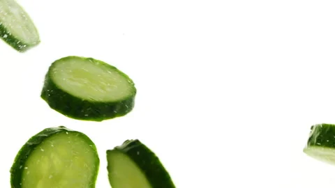 Closeup slices of fresh green cucumbers in water, vegetables on white background Stockbeeldmateriaal 271728320