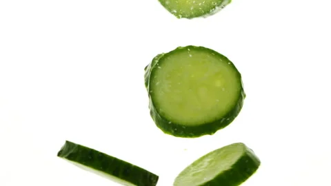 Closeup slices of fresh green cucumbers in water, vegetables on white background Stock-Footage 275570011