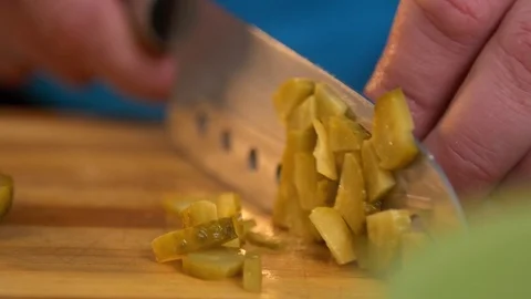 Closeup slicing pickle on cutting board Stockbeeldmateriaal 121749848