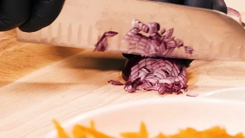 Closeup of slicing red onions with a large metal knife. Stock Footage 126489200