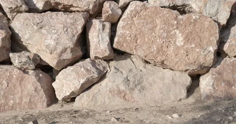 Closeup slider pan shot of texture and weathered rocks at bottom of stack  Stock Footage 315171127