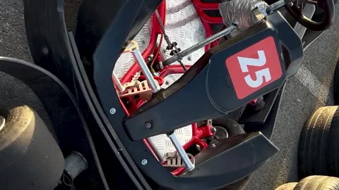 Closeup sliding across three red parked go-karts on the pit lane. Shot. Concept Stockbeeldmateriaal 256316834