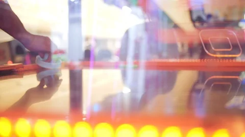 Closeup Sliding shot of someone playing air hockey with a nice parallax from Stock Footage 92463384