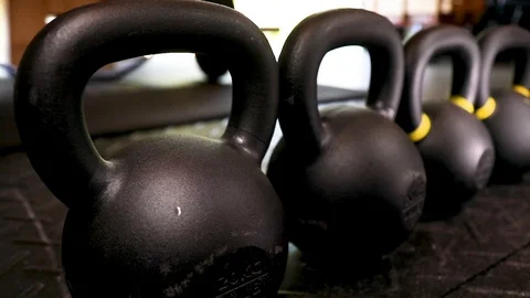 Closeup Slow Kettlebell Tracking Shot in Garage Gym Stock Footage 116500051