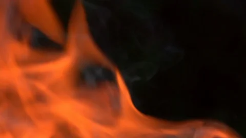 Closeup slow mo shot of real fire flames and smoke against dark green background Vídeo Stock 93728439