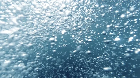 Closeup slow motion abstract video of lots of air bubbles floating up under Stock Footage 124939450