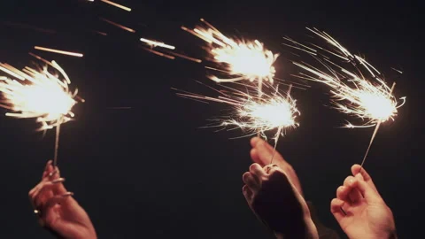 Closeup. Slow motion. Bright bengal sparkling candles or lights in darkness Stock Footage 109091536
