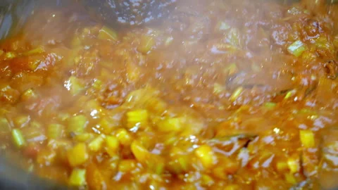 Closeup slow motion of chef is shaking ingredients in frying pan. Video stock 273983483