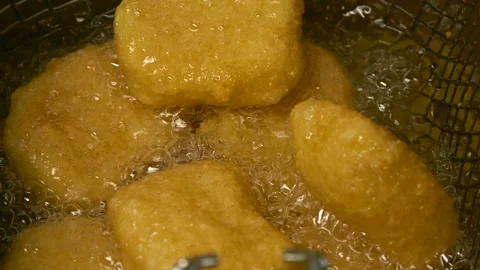 Closeup slow motion crispy fried chicken meat nuggets deep frying in boiling oil Видео 307666382