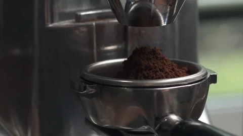 Closeup slow motion grinding fresh coffee beans into portafilter Stock Footage 85659324