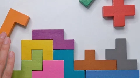 Closeup Slow motion. Hand holding piece of wooden block puzzle. wood cube Stock Footage 124528474