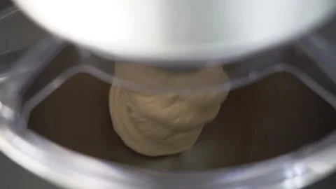 Closeup slow motion of kneading machine and dough for homemade bread and pizza Stock Footage 215920399